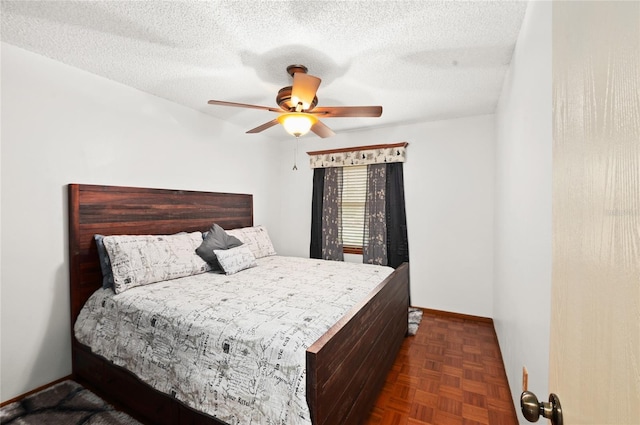 bedroom with a textured ceiling and a ceiling fan