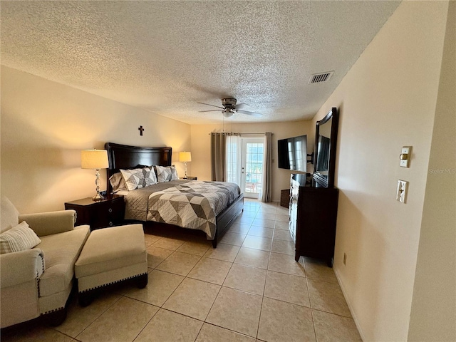 bedroom with light tile patterned floors, ceiling fan, a textured ceiling, visible vents, and access to exterior