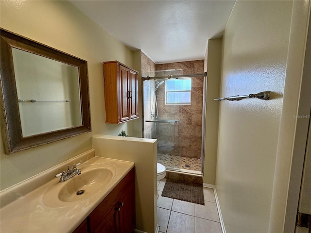 full bathroom with a stall shower, vanity, toilet, and tile patterned floors