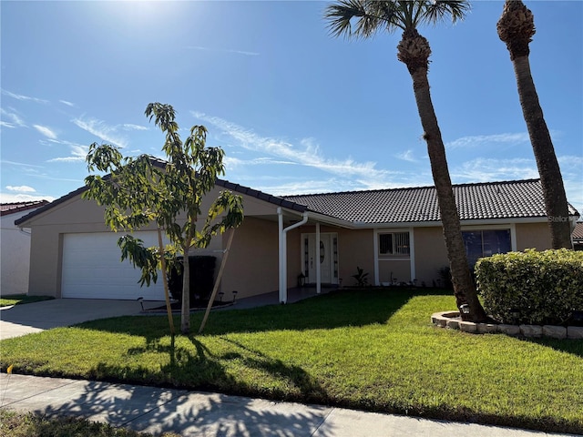 single story home with a garage, a tile roof, driveway, stucco siding, and a front lawn