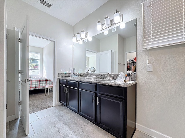 ensuite bathroom featuring visible vents, a sink, ensuite bath, and double vanity