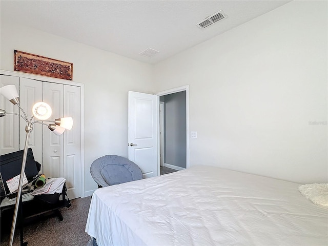 bedroom featuring carpet floors, a closet, and visible vents