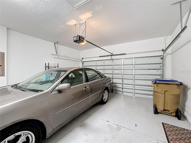 garage featuring electric panel and a garage door opener