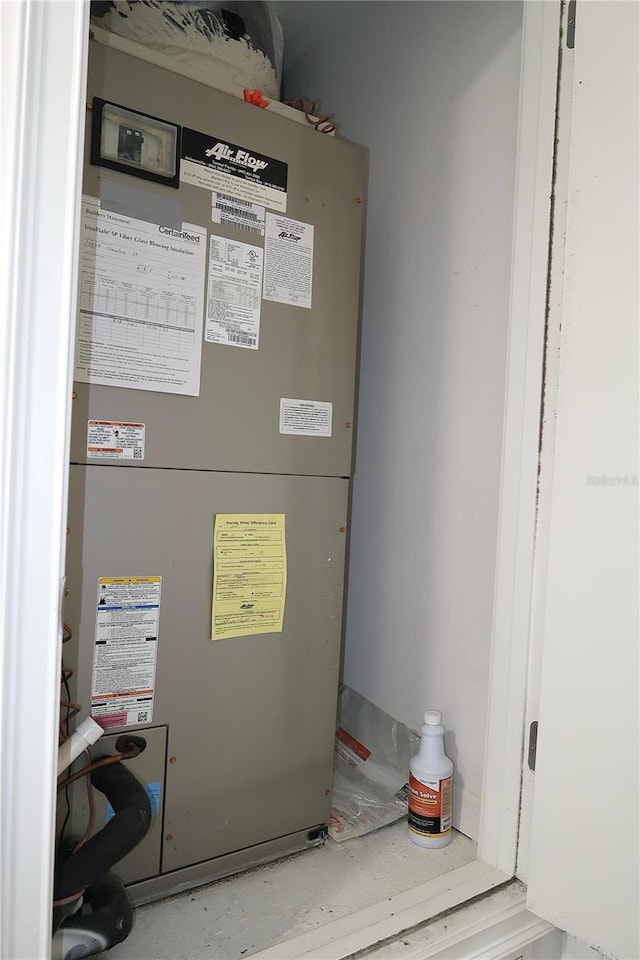 utility room featuring heating unit