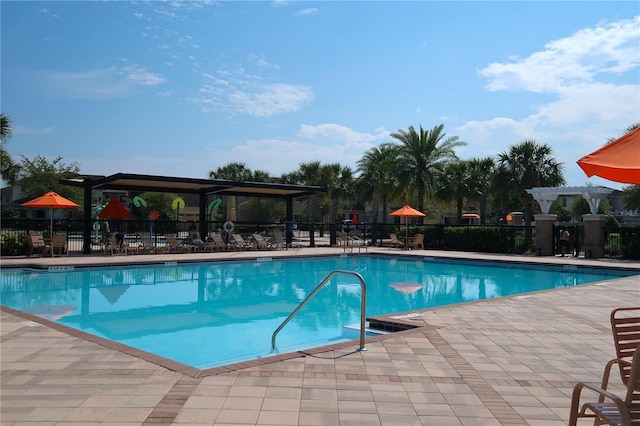 pool featuring a patio area, fence, and a pergola