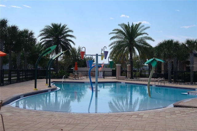 community pool featuring a patio area and fence