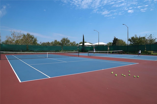 view of sport court featuring community basketball court and fence