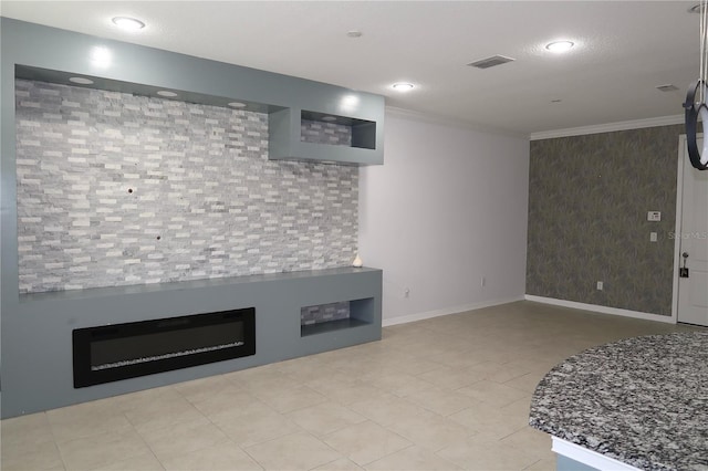 interior space with visible vents, baseboards, and crown molding