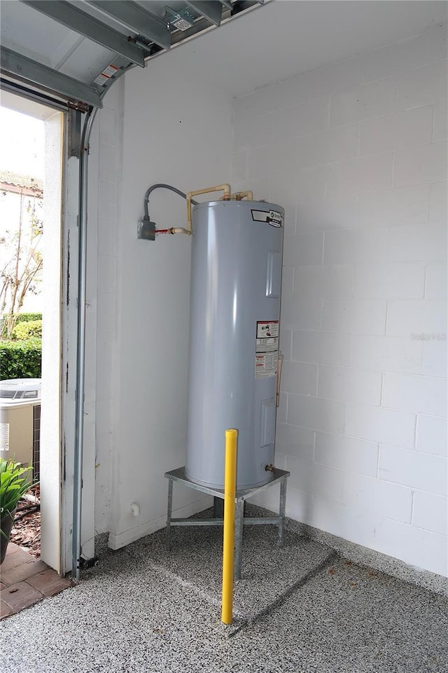 garage with electric water heater and central AC unit