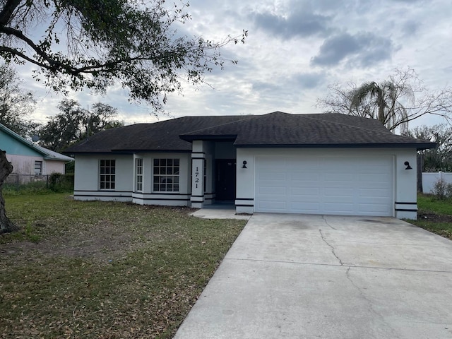 single story home with driveway, a garage, fence, and a front lawn