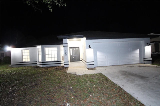 view of front facade featuring driveway and stucco siding