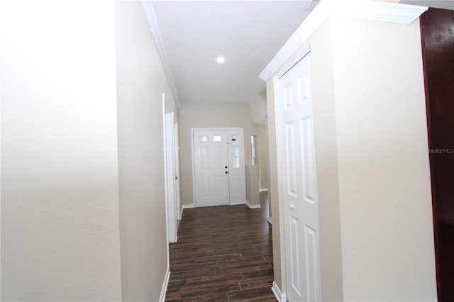 hallway featuring dark wood-style floors, recessed lighting, crown molding, and baseboards