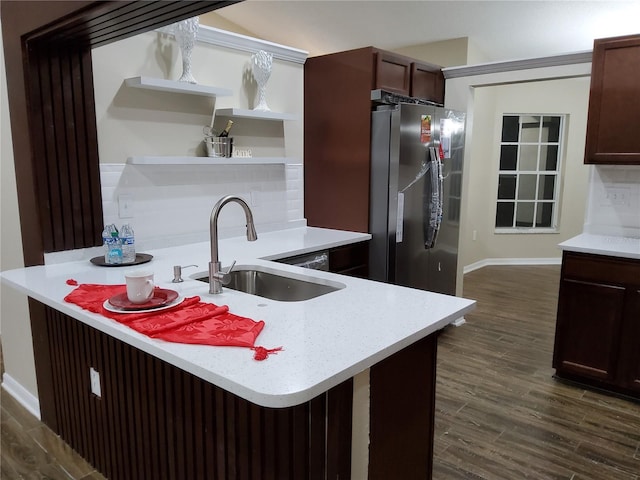 kitchen with stainless steel fridge, dark wood finished floors, decorative backsplash, open shelves, and a sink