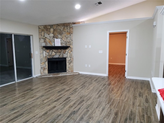 unfurnished living room with baseboards, visible vents, wood finished floors, vaulted ceiling, and a fireplace