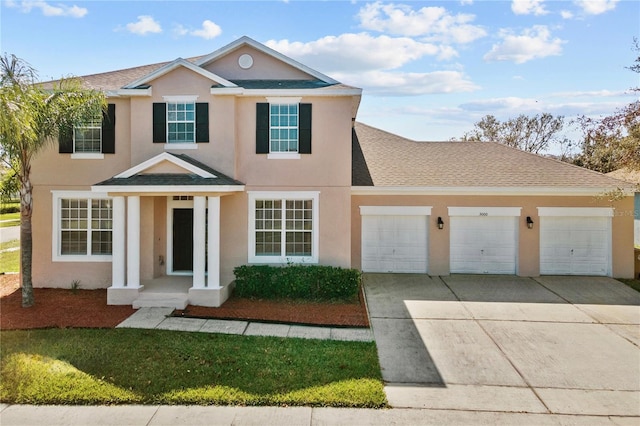 view of front facade featuring a garage, driveway, a shingled roof, and stucco siding