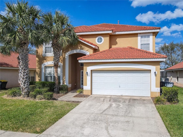 mediterranean / spanish-style home with a garage, driveway, a tiled roof, and stucco siding