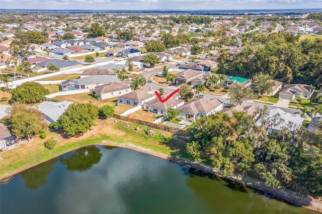 drone / aerial view featuring a residential view and a water view