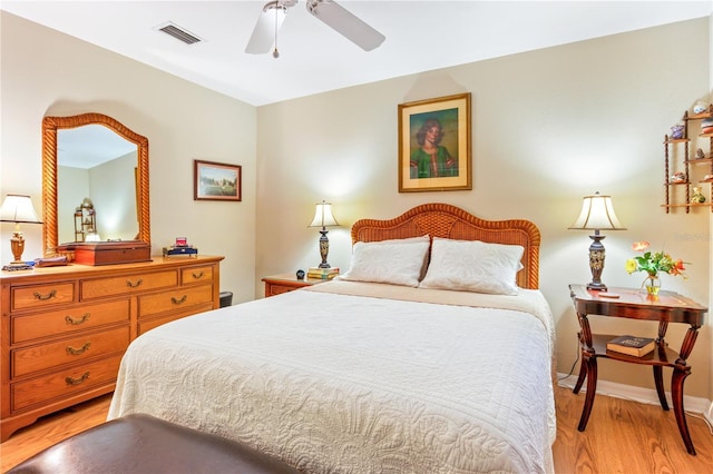 bedroom with light wood-style flooring, visible vents, and baseboards