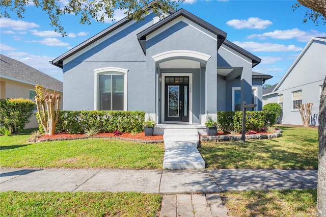 view of front of property with a front lawn and stucco siding