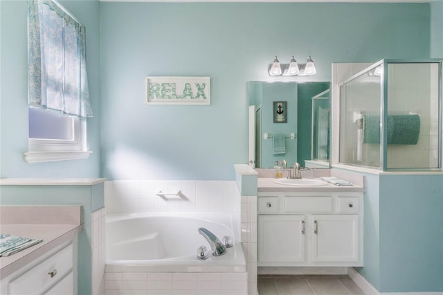 3320 Ashmount Dr, Orlando, FL 32828 - bathroom featuring a garden tub, vanity, a shower stall, and tile patterned floors