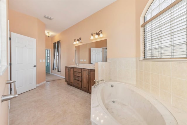 full bath featuring a garden tub, a sink, visible vents, a healthy amount of sunlight, and double vanity