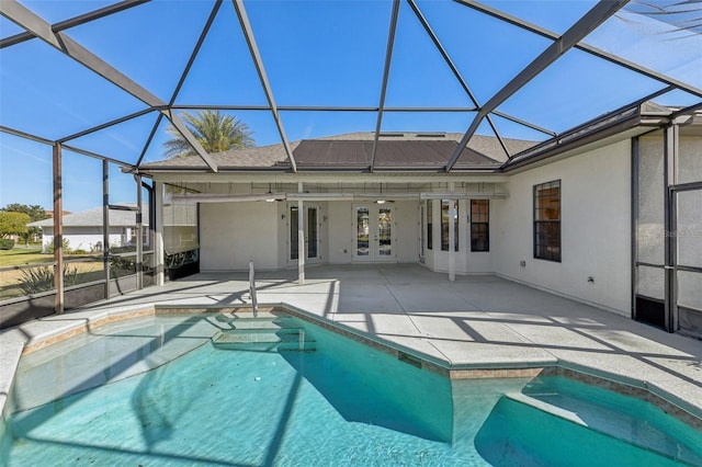 outdoor pool with french doors, a patio, and a lanai