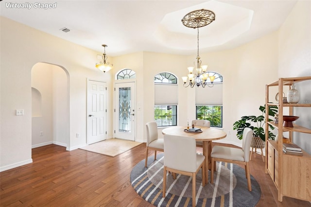 12018 SE 175th Loop, Summerfield, FL 34491 - dining room with wood finished floors, arched walkways, a chandelier, and baseboards
