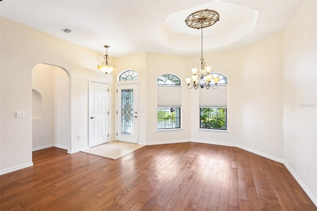 12018 SE 175th Loop, Summerfield, FL 34491 - entryway with arched walkways, hardwood / wood-style flooring, a chandelier, and baseboards