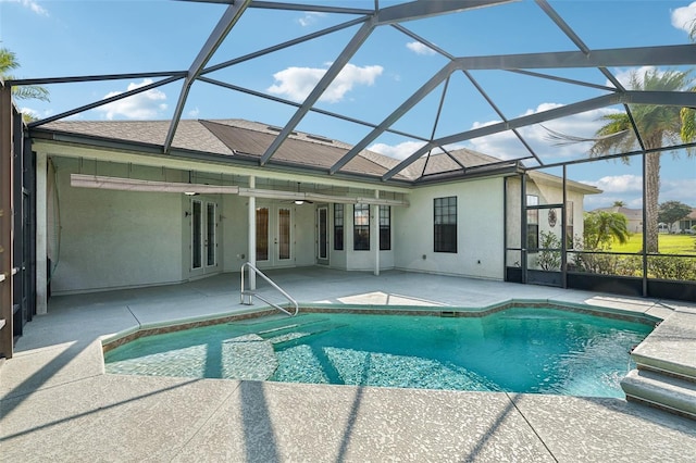 12018 SE 175th Loop, Summerfield, FL 34491 - swimming pool with french doors, a patio area, and glass enclosure