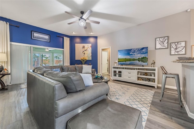 living room with ceiling fan, wood finished floors, and baseboards