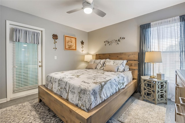 bedroom with a ceiling fan and wood finished floors