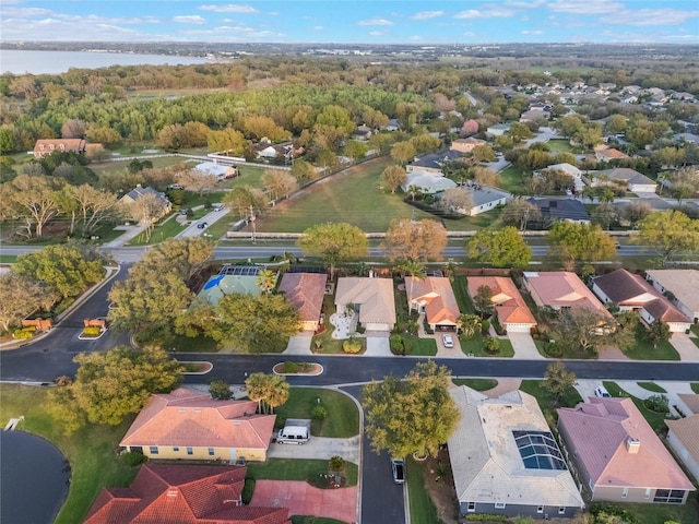 birds eye view of property with a residential view, a water view, and a forest view