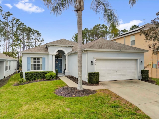 view of front of house with an attached garage, a shingled roof, driveway, stucco siding, and a front yard