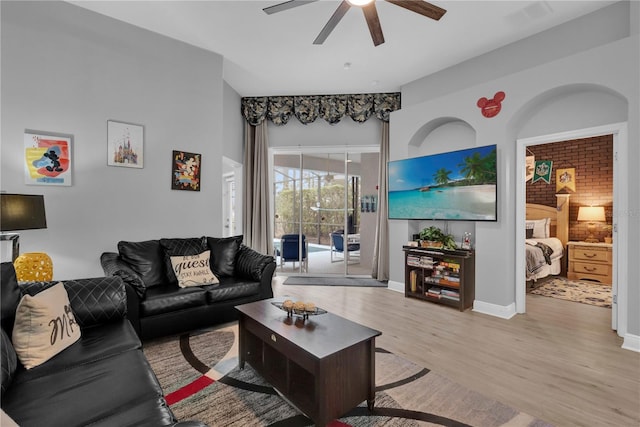 living room featuring visible vents, ceiling fan, light wood-style flooring, and baseboards