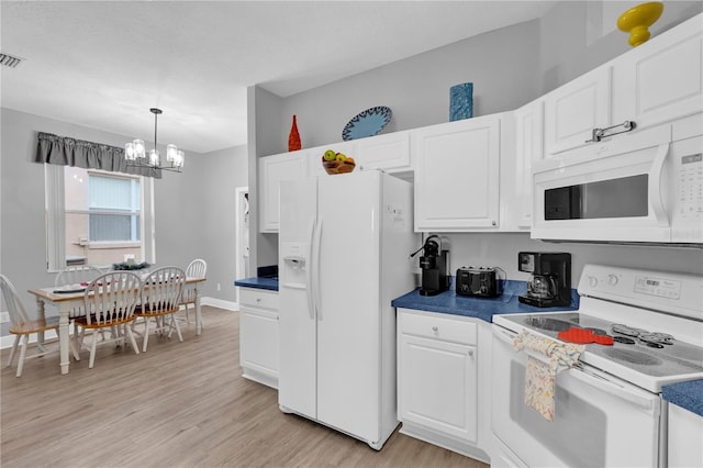 kitchen with dark countertops, white appliances, light wood-style flooring, and white cabinetry