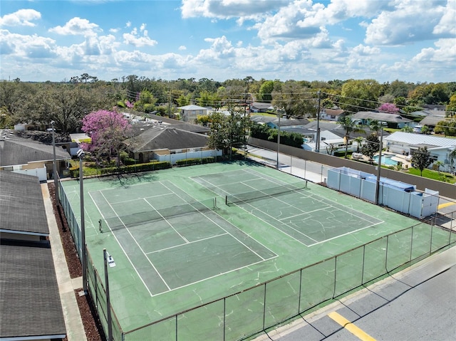 view of tennis court featuring fence