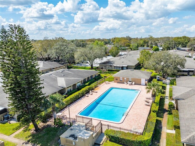 pool with a residential view, a patio, and fence