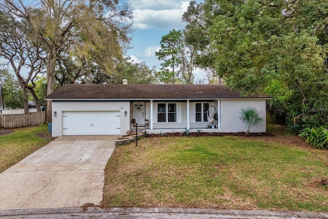 single story home featuring stucco siding, a front yard, fence, a garage, and driveway