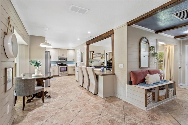 kitchen with light tile patterned floors, visible vents, appliances with stainless steel finishes, and light countertops