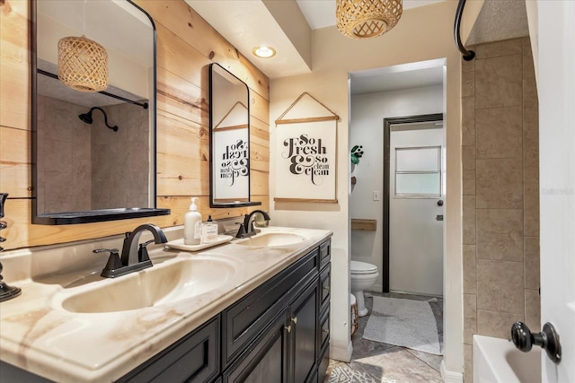 full bath featuring a sink, toilet, and double vanity