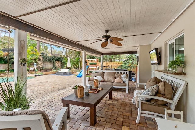 view of patio / terrace with ceiling fan, outdoor lounge area, a fenced backyard, and a fenced in pool