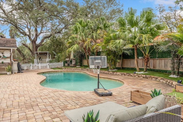 view of pool featuring a fenced in pool, a patio area, a fenced backyard, and an outdoor living space