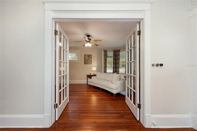 hall featuring baseboards, dark wood finished floors, and french doors