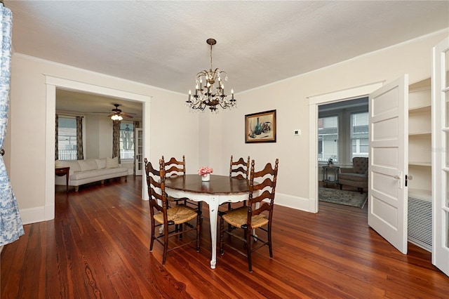 dining area featuring dark wood-type flooring, crown molding, a textured ceiling, and baseboards