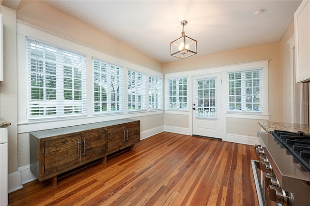 sunroom featuring a chandelier and a wealth of natural light