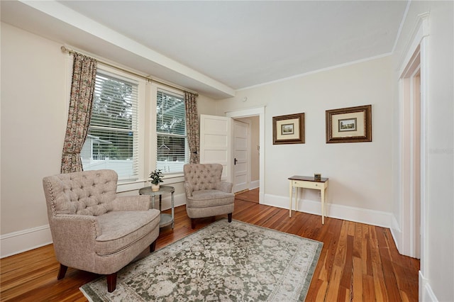 sitting room featuring baseboards and wood finished floors