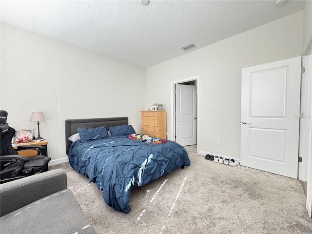 bedroom featuring baseboards, visible vents, a textured ceiling, and light colored carpet