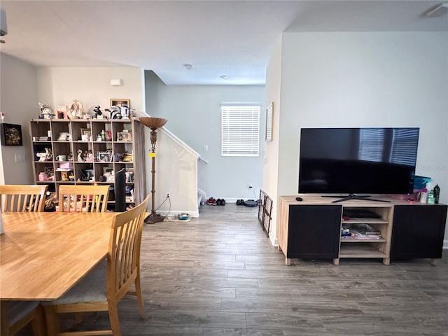 dining area with baseboards and wood finished floors