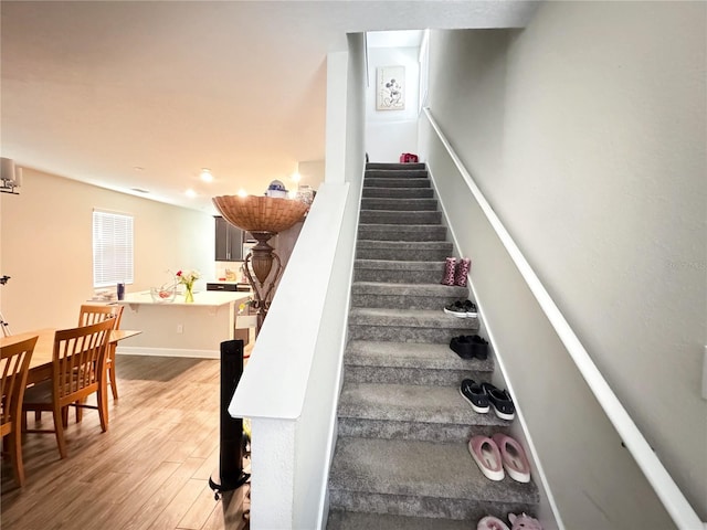 stairs featuring baseboards and wood finished floors