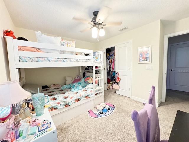 bedroom featuring visible vents, light carpet, ceiling fan, a textured ceiling, and baseboards